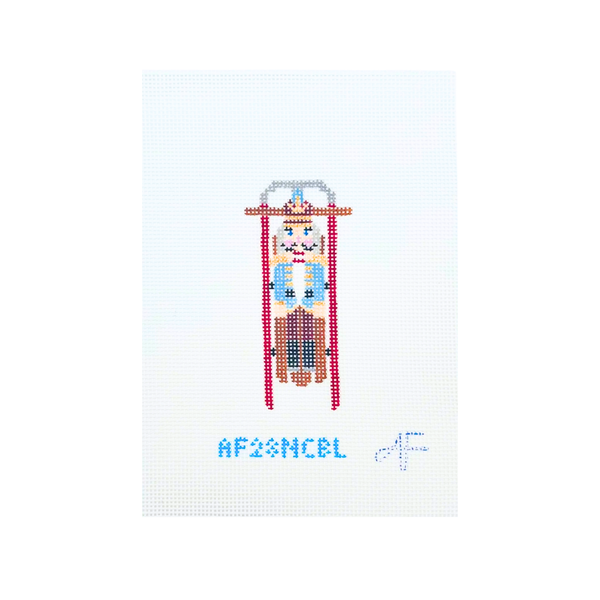 Sled with Blue Nutcracker — Anne Fisher Needlepoint