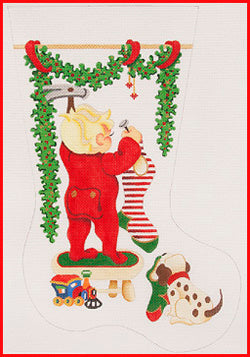 Boy on Stool Hanging Stocking with Train